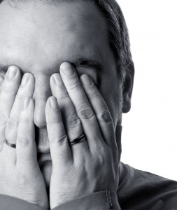 Man hiding face from management jargon